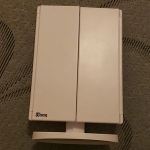 An adjustable white stand up mirror